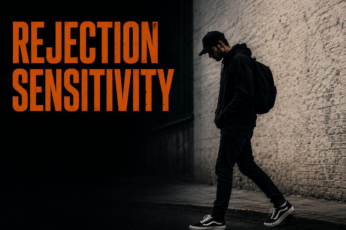 A man in a black hoodie, backpack, and cap walks with his head down past a concrete wall, with a dark swirling ink-smoke shape rising beside him